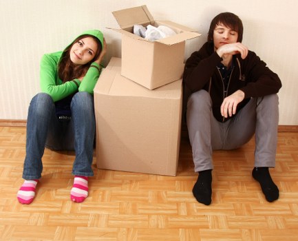 Local movers handling furniture in a residential North London street